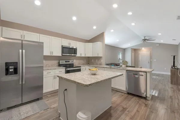 a kitchen with a refrigerator sink and microwave