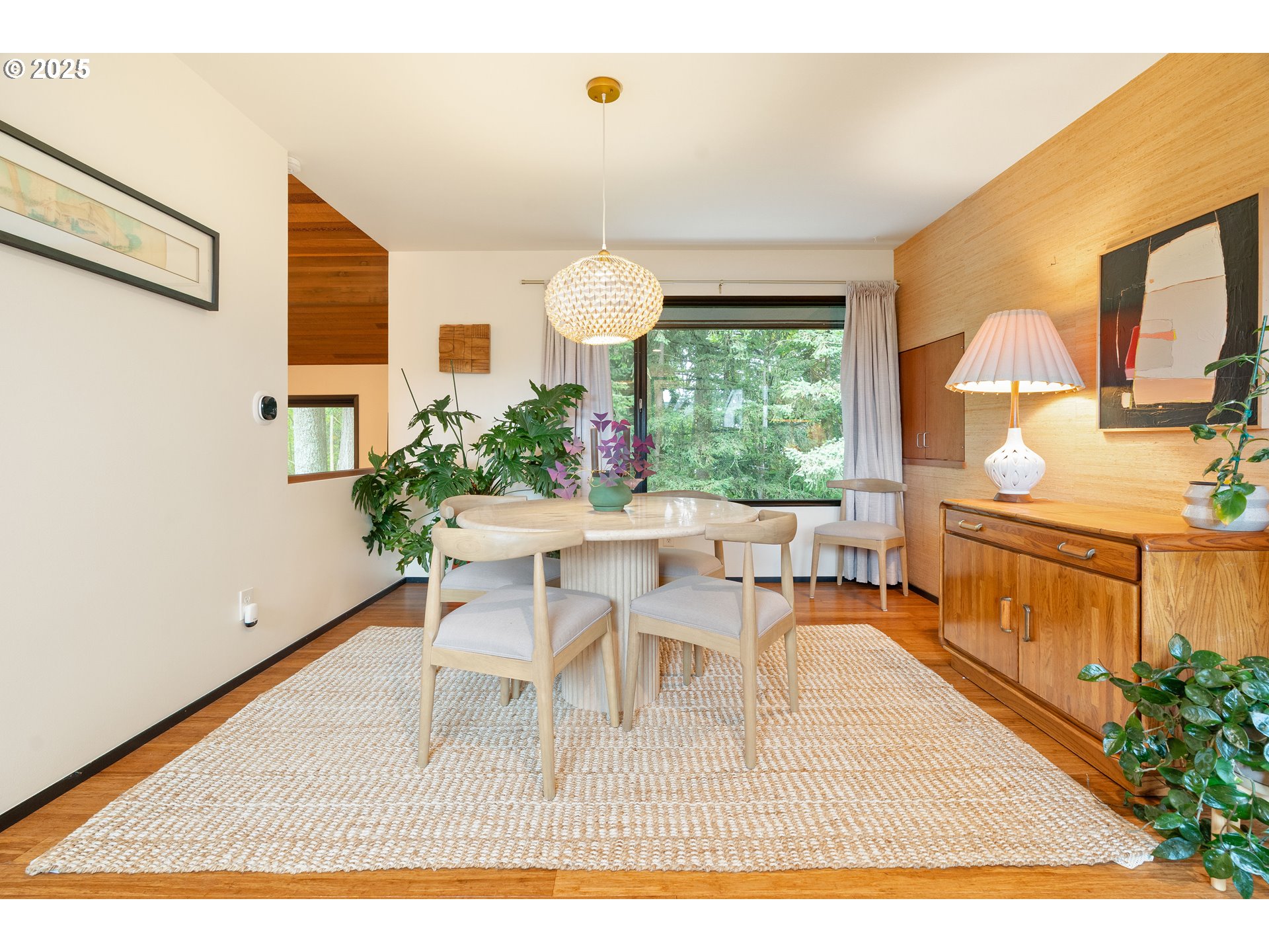 1555 Southwest Miller Court Gresham, OR 97080 - Photo 11 of 47 a dining room with furniture a potted plant and wooden floor