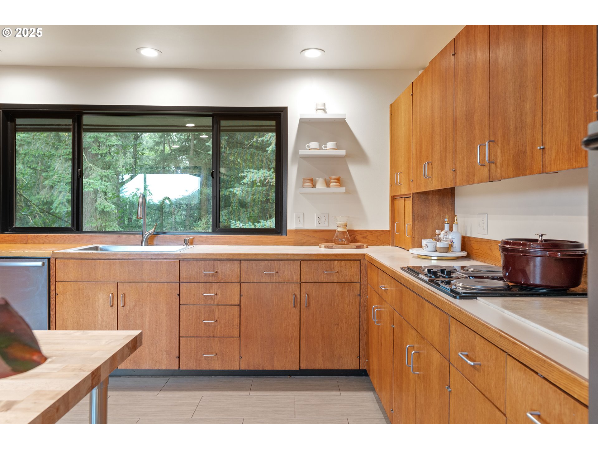 1555 Southwest Miller Court Gresham, OR 97080 - Photo 18 of 47 a kitchen with granite countertop a stove a sink and white cabinets with wooden floor
