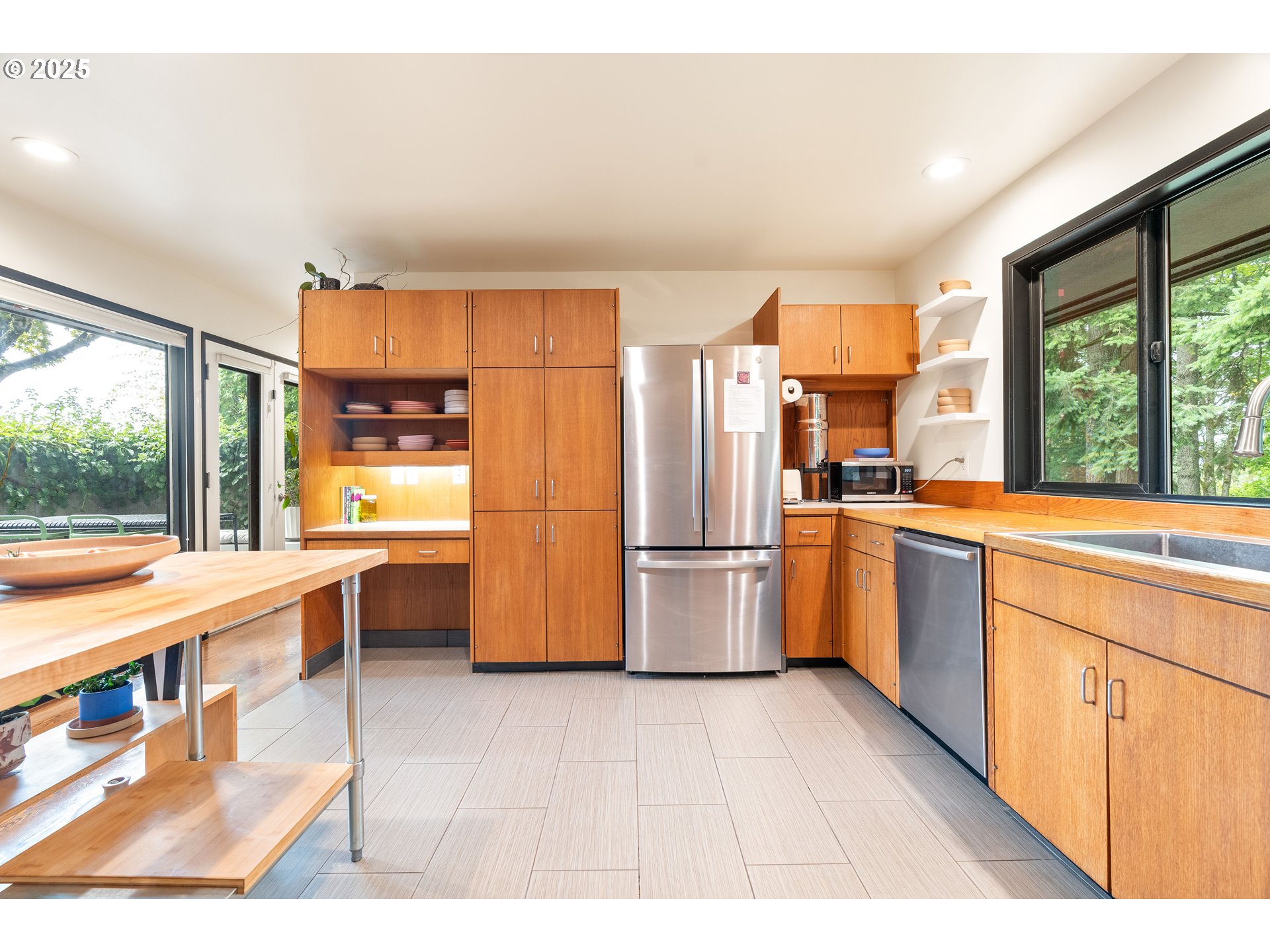 1555 Southwest Miller Court Gresham, OR 97080 - Photo 19 of 47 a kitchen with stainless steel appliances a refrigerator a sink dishwasher with a dining table and chairs