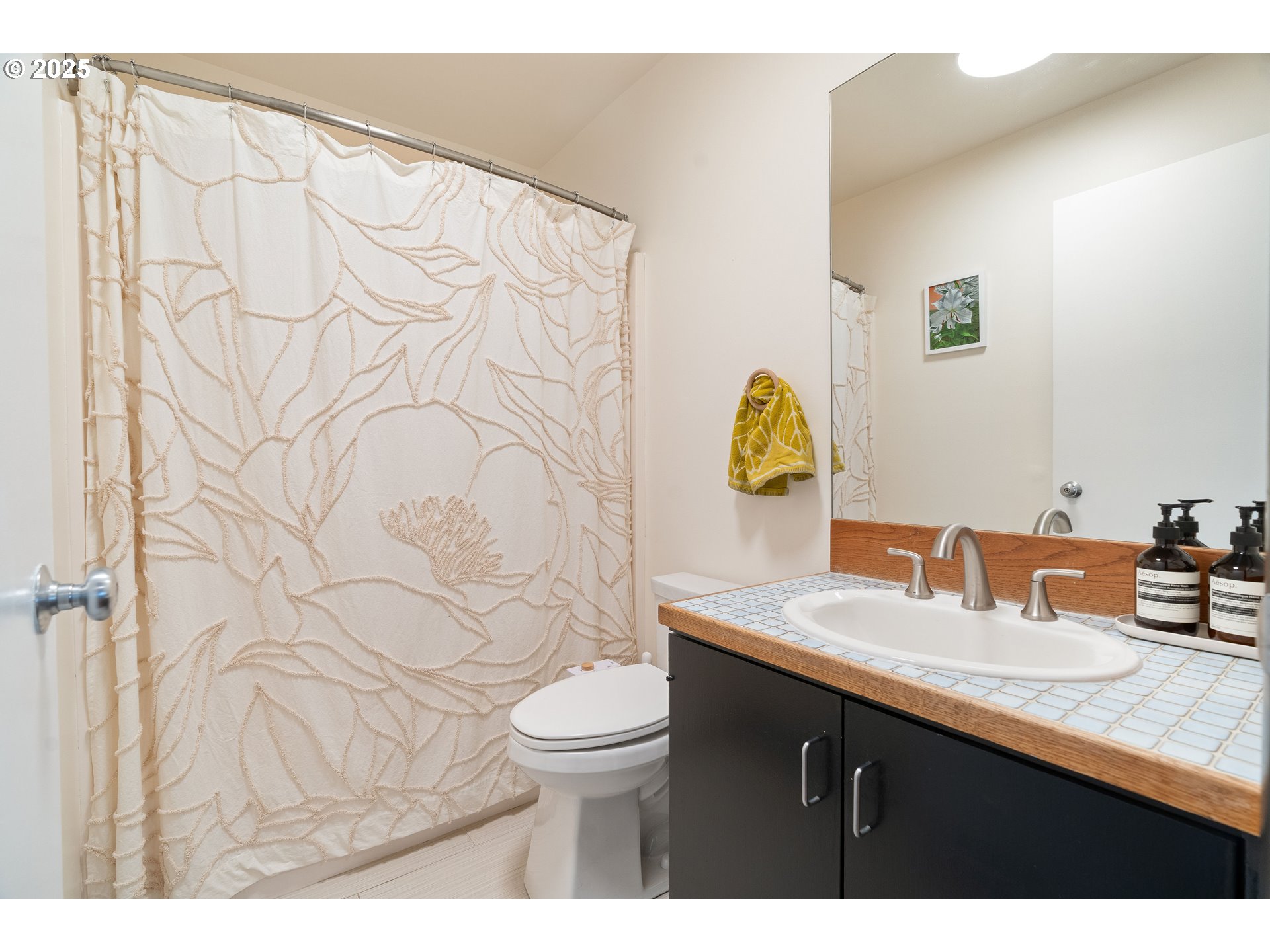 1555 Southwest Miller Court Gresham, OR 97080 - Photo 23 of 47 a bathroom with a granite countertop sink a toilet and a mirror