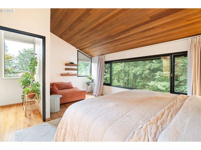 a bedroom with a bed and a large window