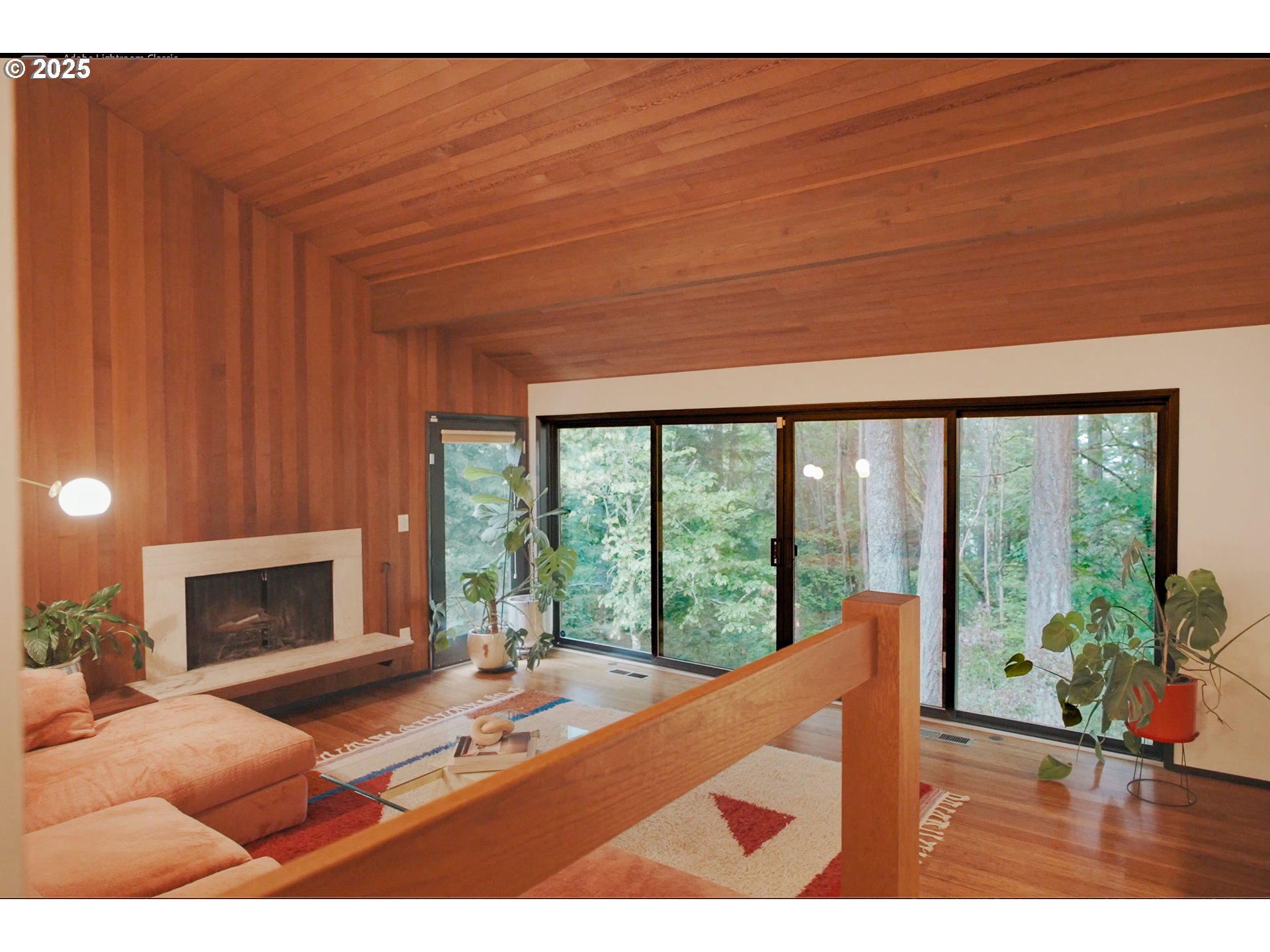 1555 Southwest Miller Court Gresham, OR 97080 - Photo 3 of 47 a living room with furniture a fireplace and a floor to ceiling window