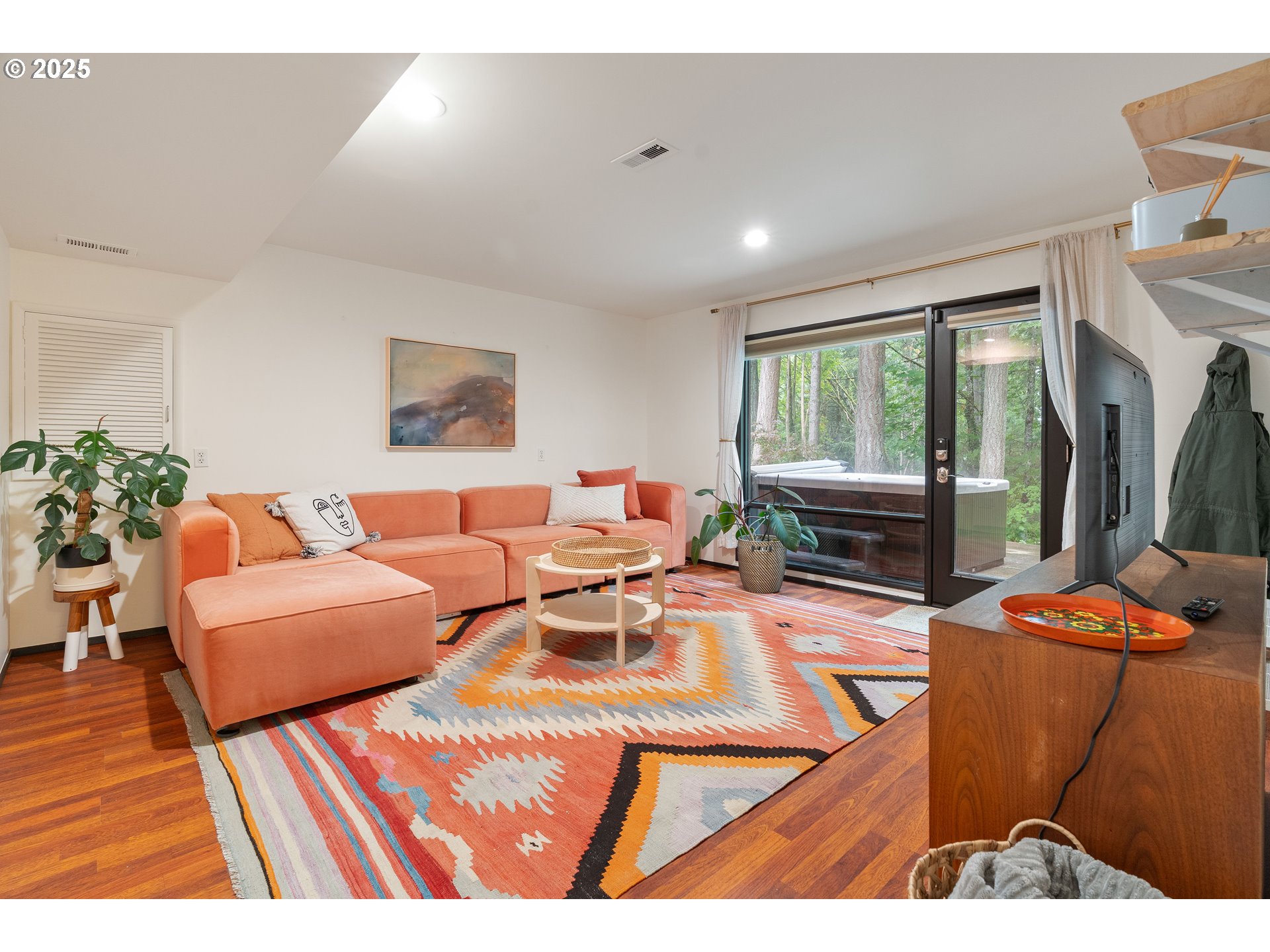 1555 Southwest Miller Court Gresham, OR 97080 - Photo 33 of 47 a living room with furniture a rug and a floor to ceiling window