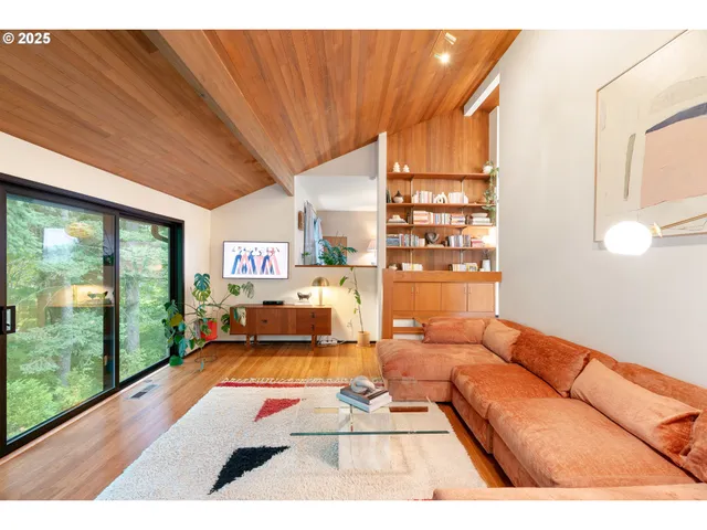 a living room with patio furniture and a floor to ceiling window