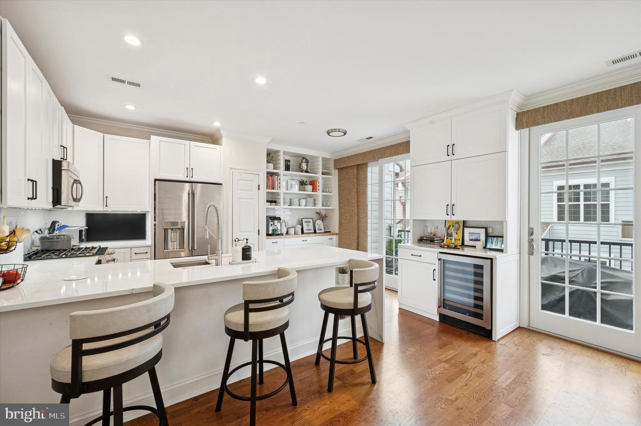 610 Captains Way Philadelphia, PA 19146 - Photo 8 of 25 a kitchen with stainless steel appliances kitchen island granite countertop a stove a sink a dining table and chairs