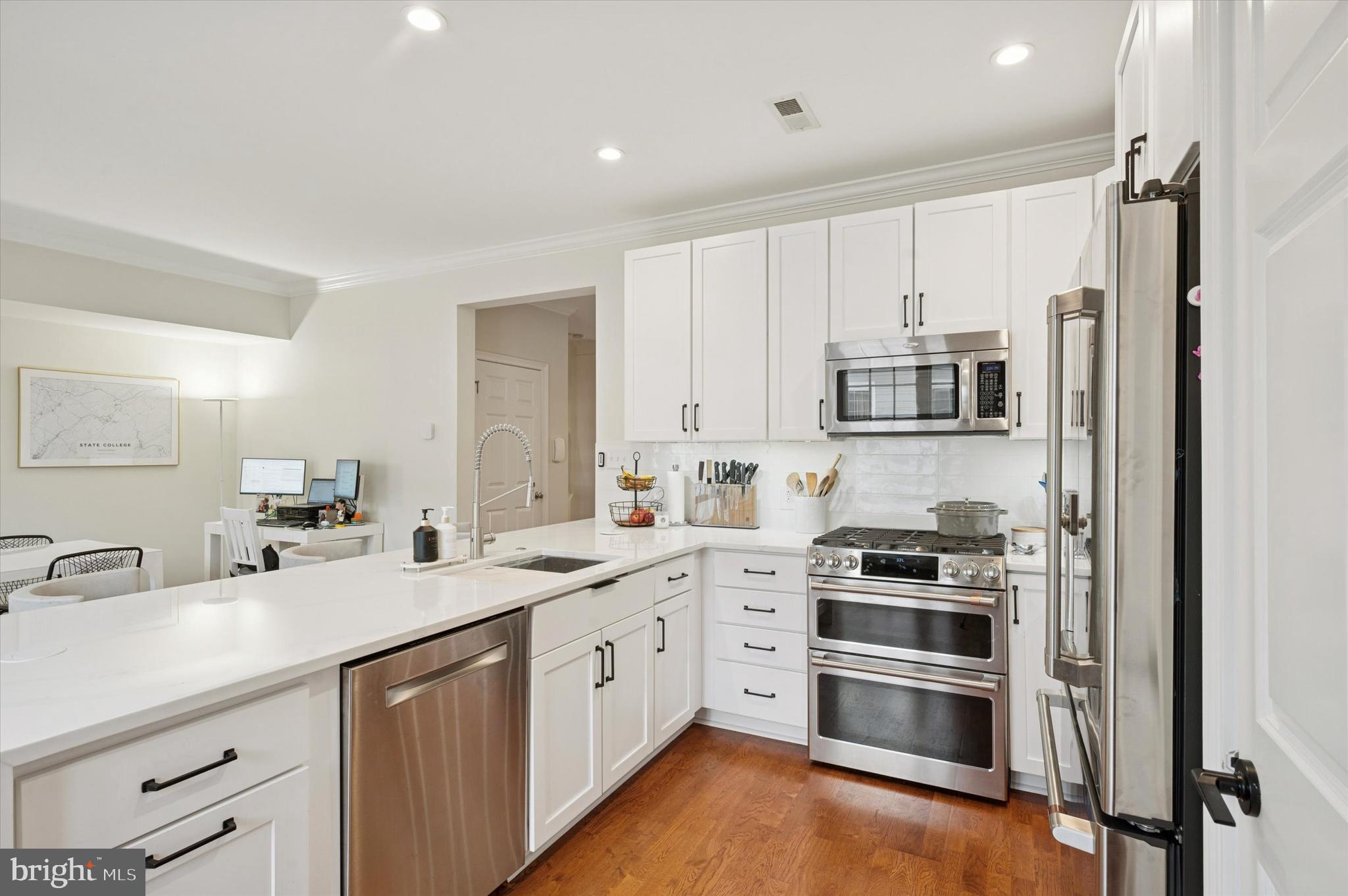 610 Captains Way Philadelphia, PA 19146 - Photo 10 of 25 a kitchen with a sink white cabinets and stainless steel appliances