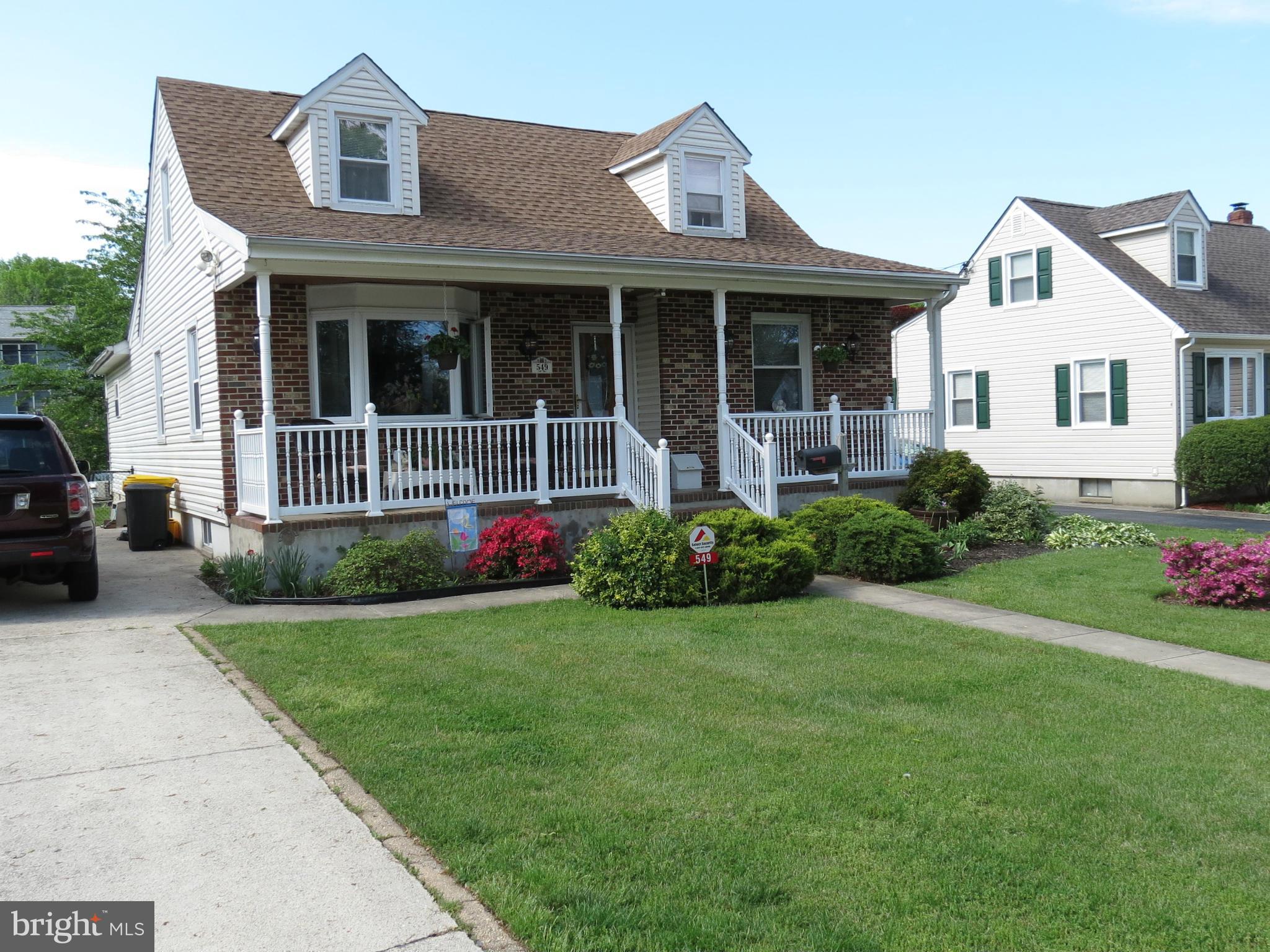 a front view of a house with a garden and porch