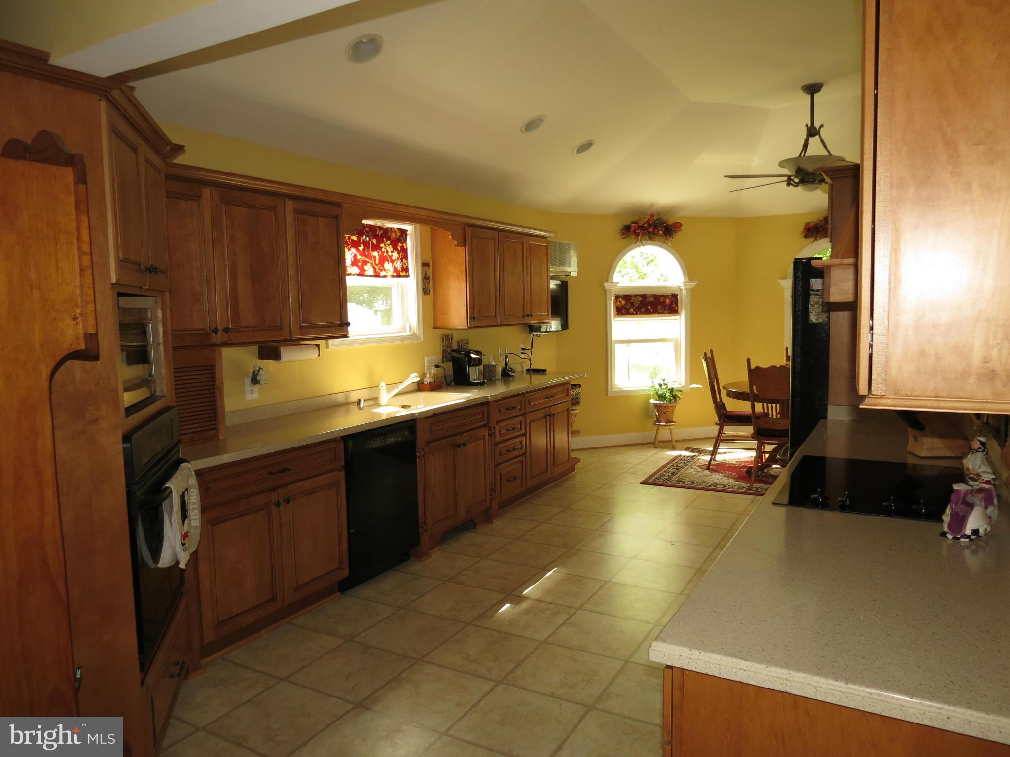 549 Forest View Road Linthicum Heights, MD 21090 - Photo 3 of 30 a kitchen with a sink and a refrigerator