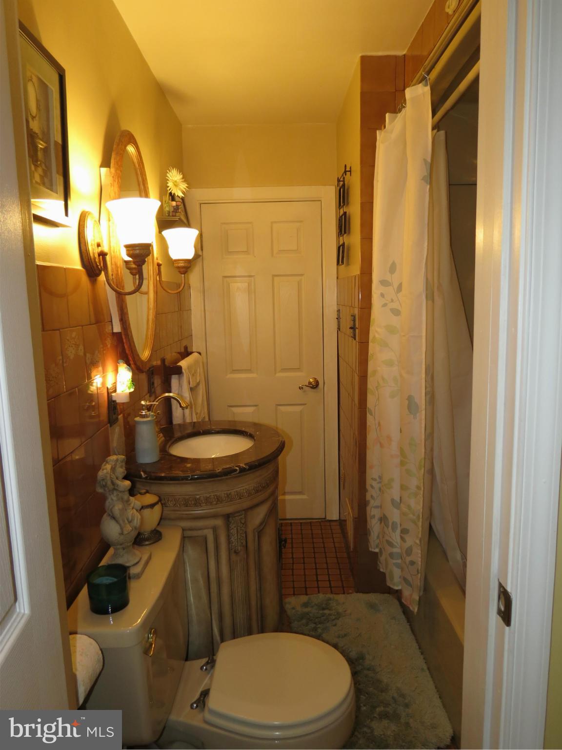 549 Forest View Road Linthicum Heights, MD 21090 - Photo 9 of 30 a bathroom with a sink a toilet a mirror and shower
