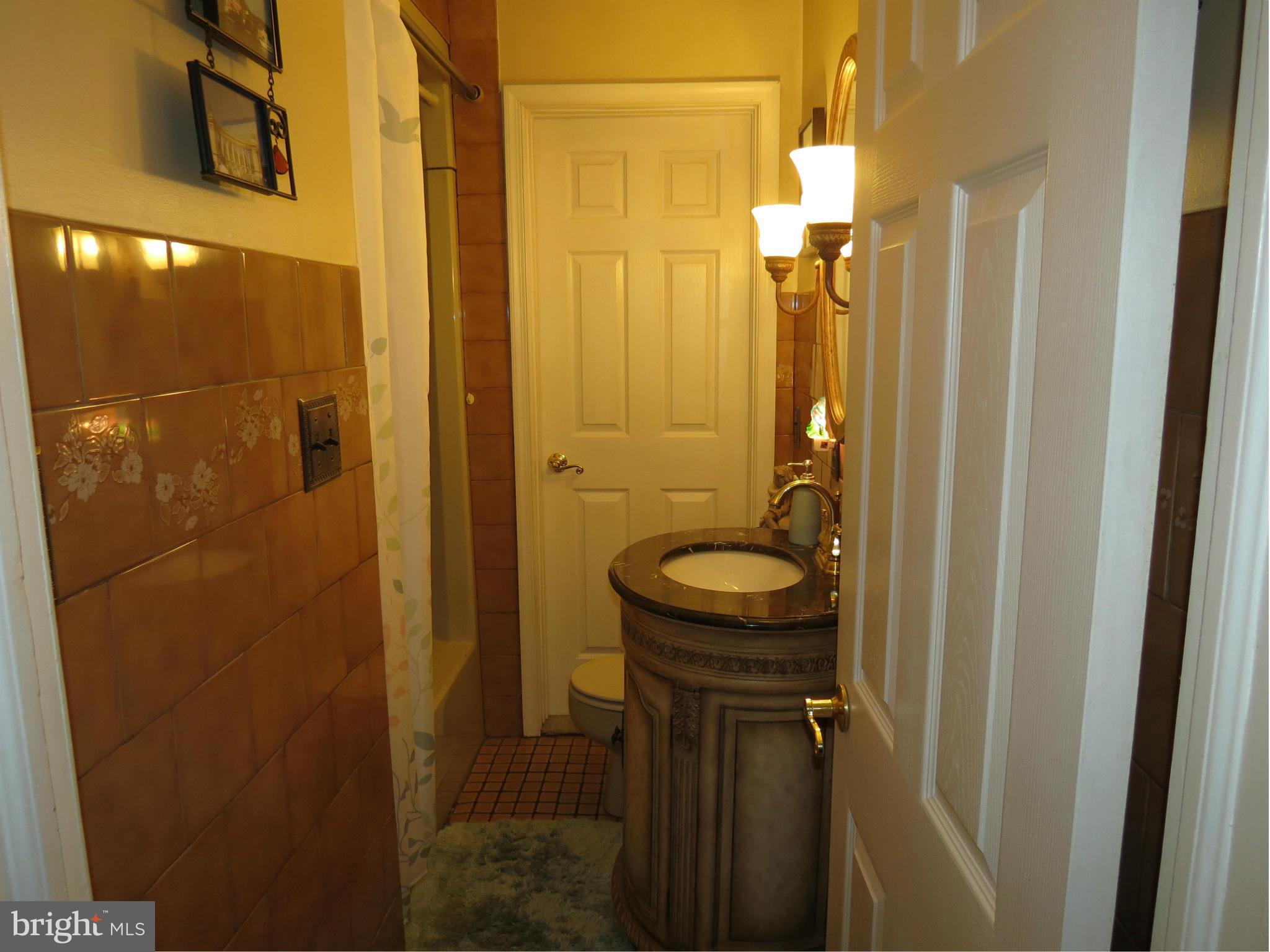 549 Forest View Road Linthicum Heights, MD 21090 - Photo 10 of 30 a bathroom with a granite countertop shower a sink and toilet
