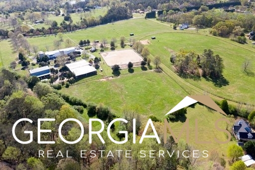 460 Dixie Road Covington, GA 30014 - Photo 62 of 91 an aerial view of a residential apartment building with a yard and parking spaces