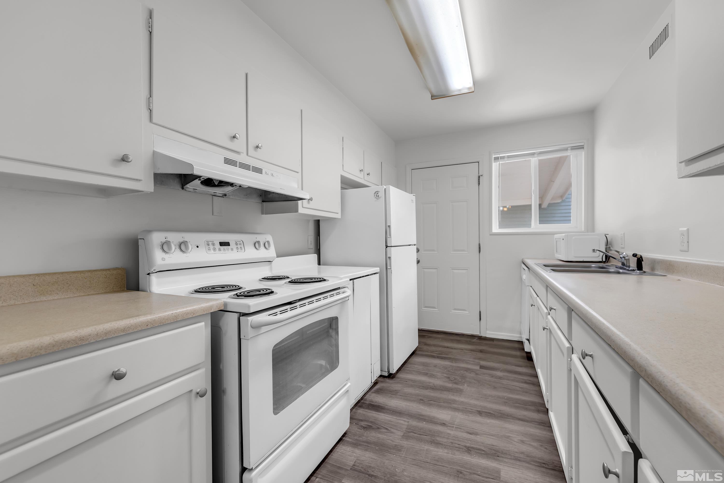12000 Rocky Mountain Street Reno, NV 89506 - Photo 1 of 40 a kitchen with granite countertop white cabinets and white appliances
