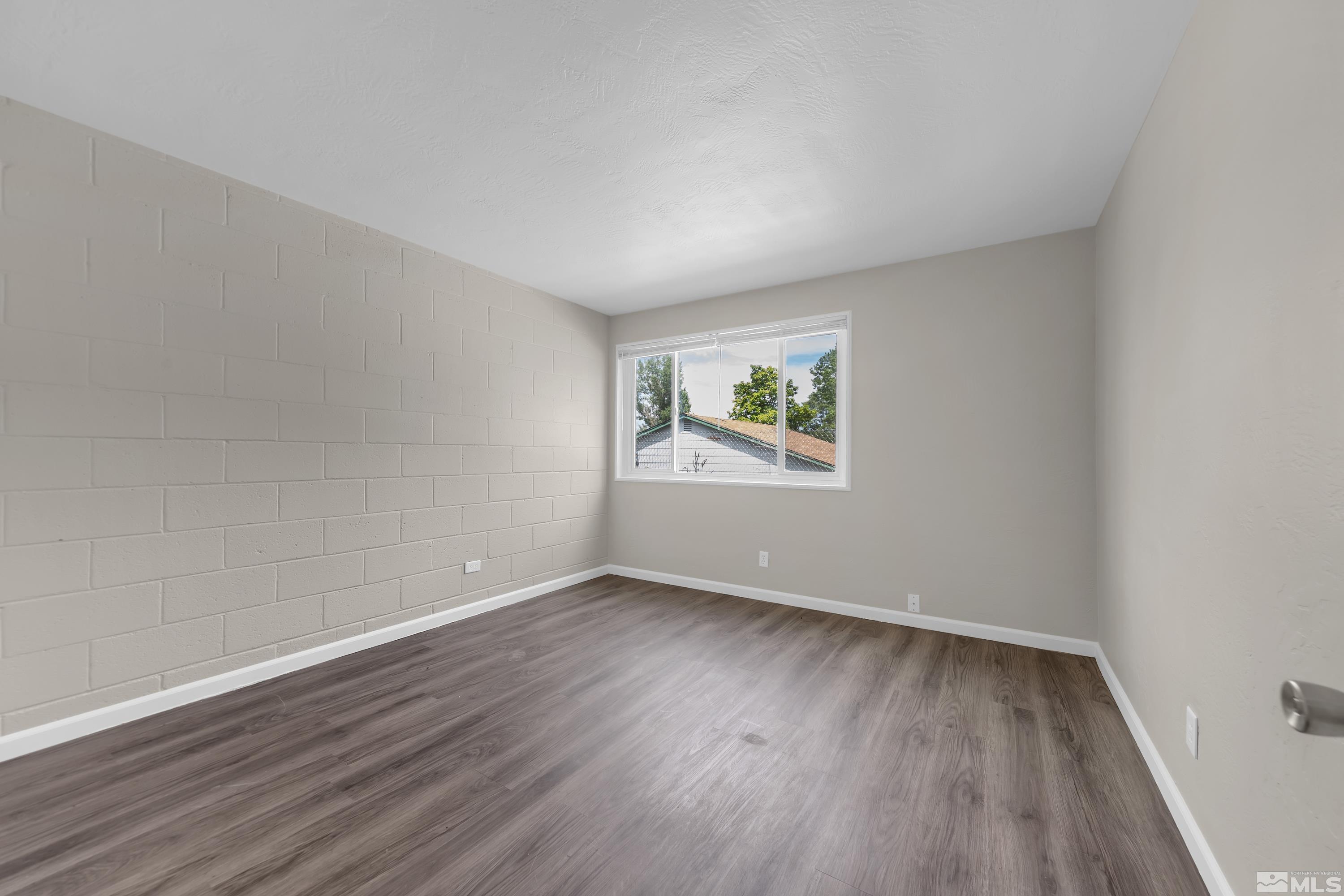12000 Rocky Mountain Street Reno, NV 89506 - Photo 12 of 40 a view of an empty room with wooden floor and a window