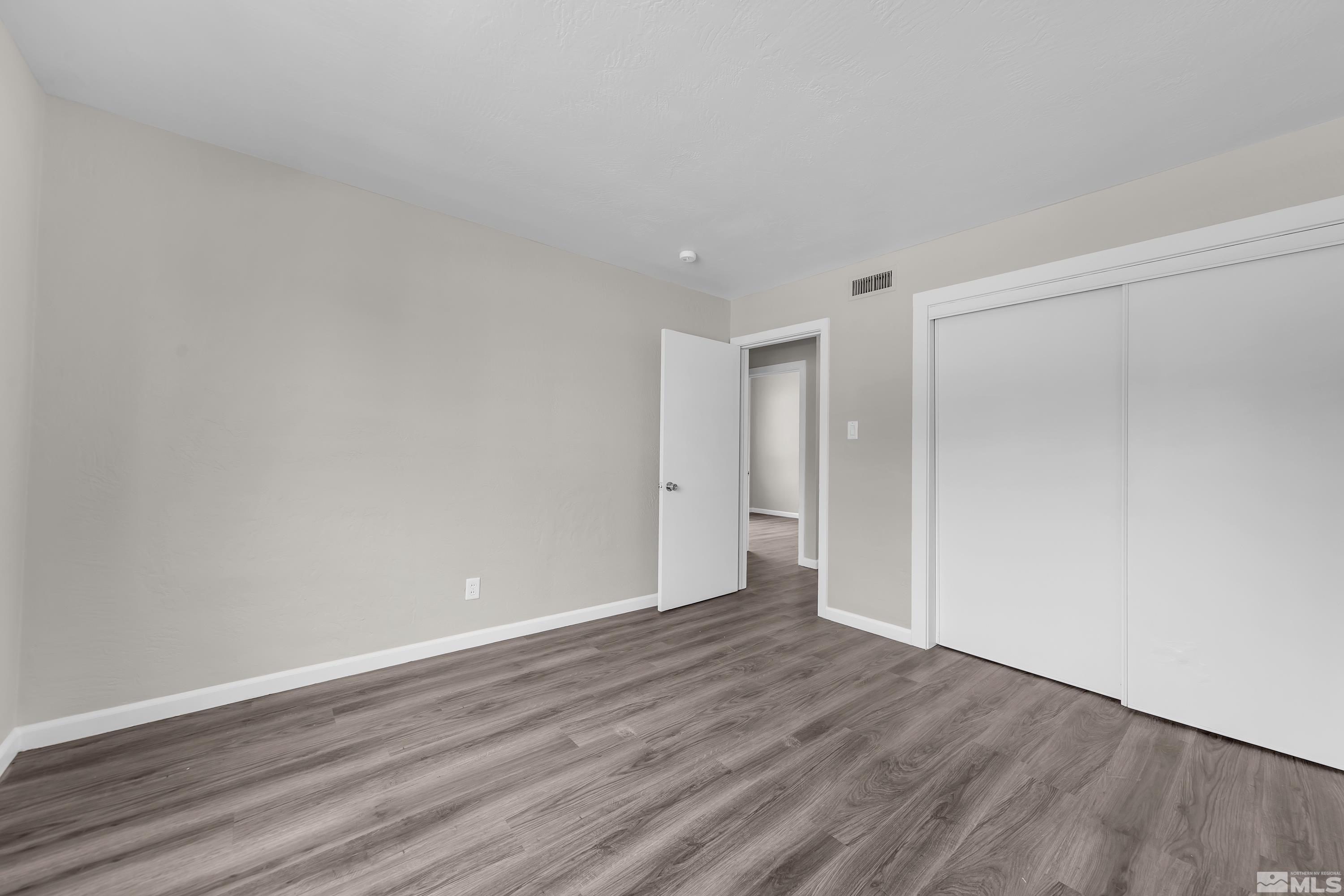 12000 Rocky Mountain Street Reno, NV 89506 - Photo 13 of 40 a view of an empty room and wooden floor
