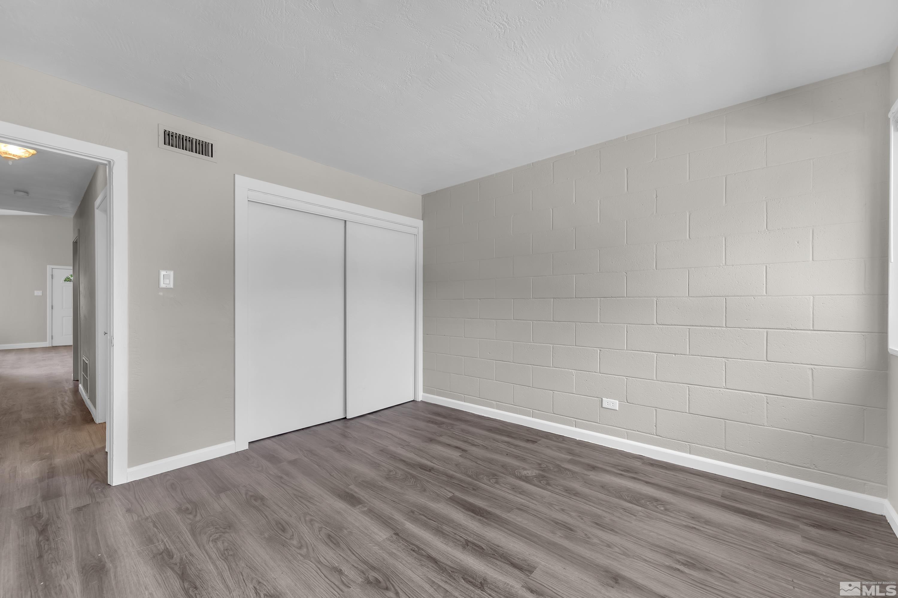 12000 Rocky Mountain Street Reno, NV 89506 - Photo 14 of 40 a view of an empty room with wooden floor and closet