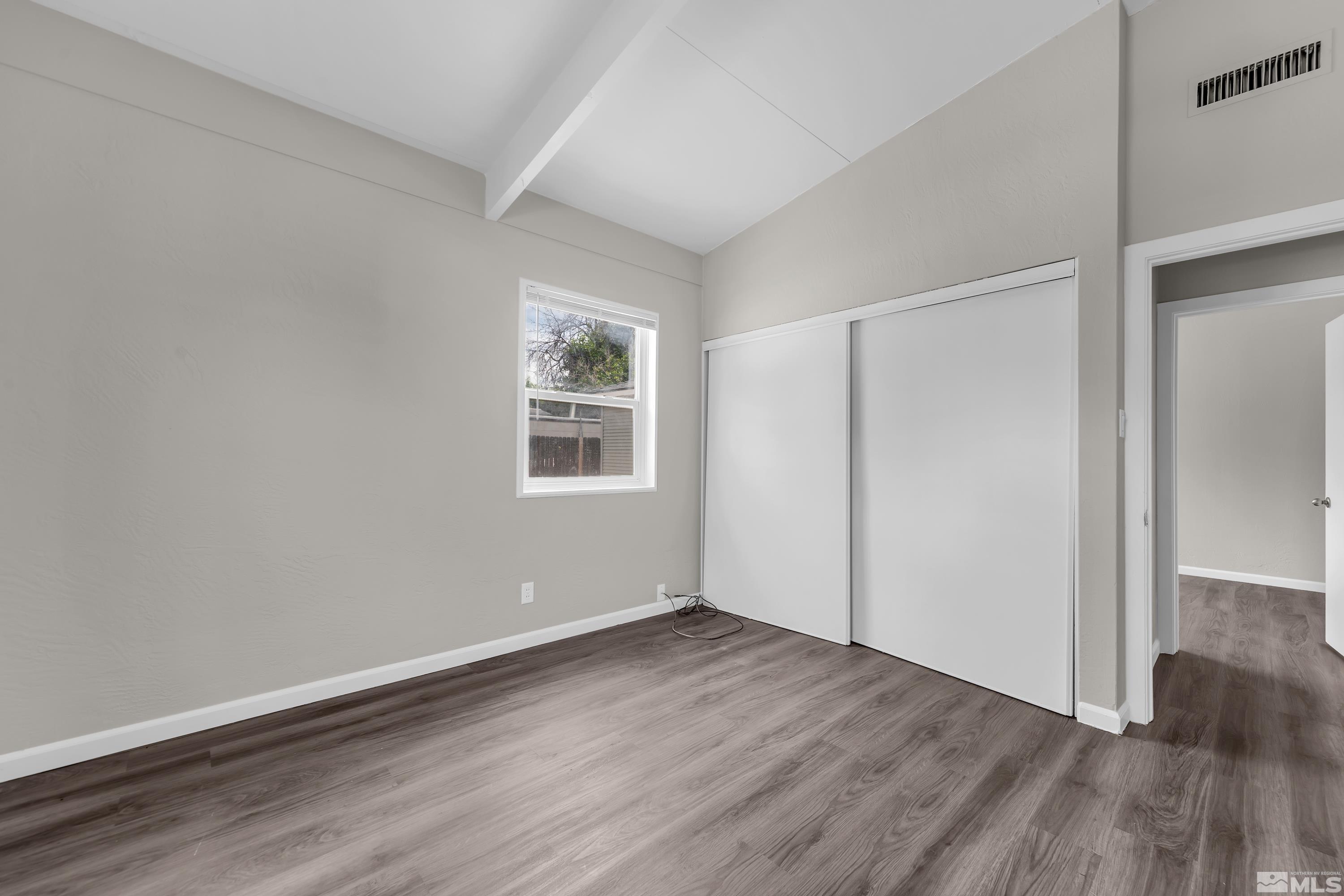 12000 Rocky Mountain Street Reno, NV 89506 - Photo 16 of 40 an empty room with wooden floor and windows