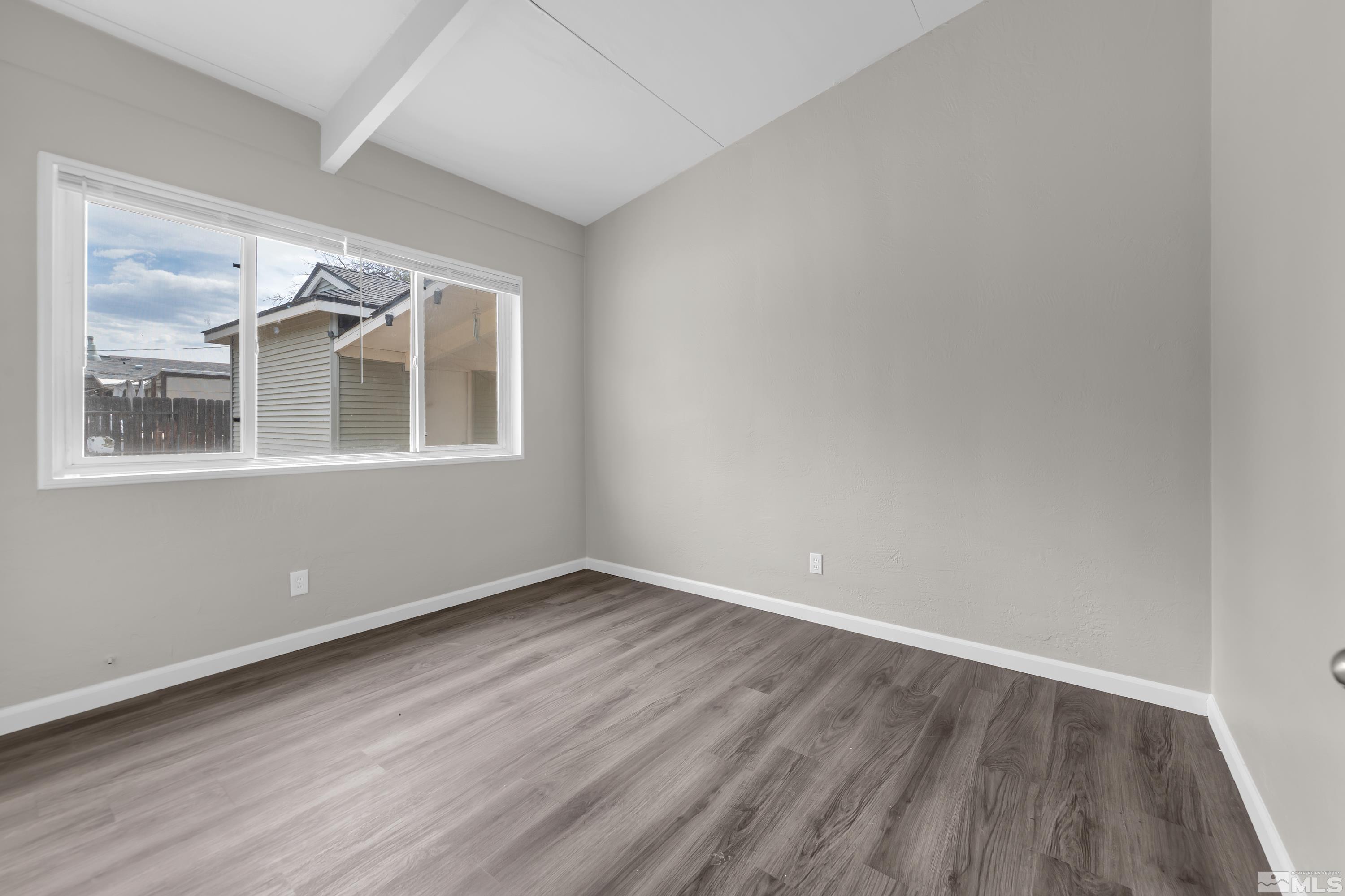 12000 Rocky Mountain Street Reno, NV 89506 - Photo 17 of 40 an empty room with wooden floor and windows