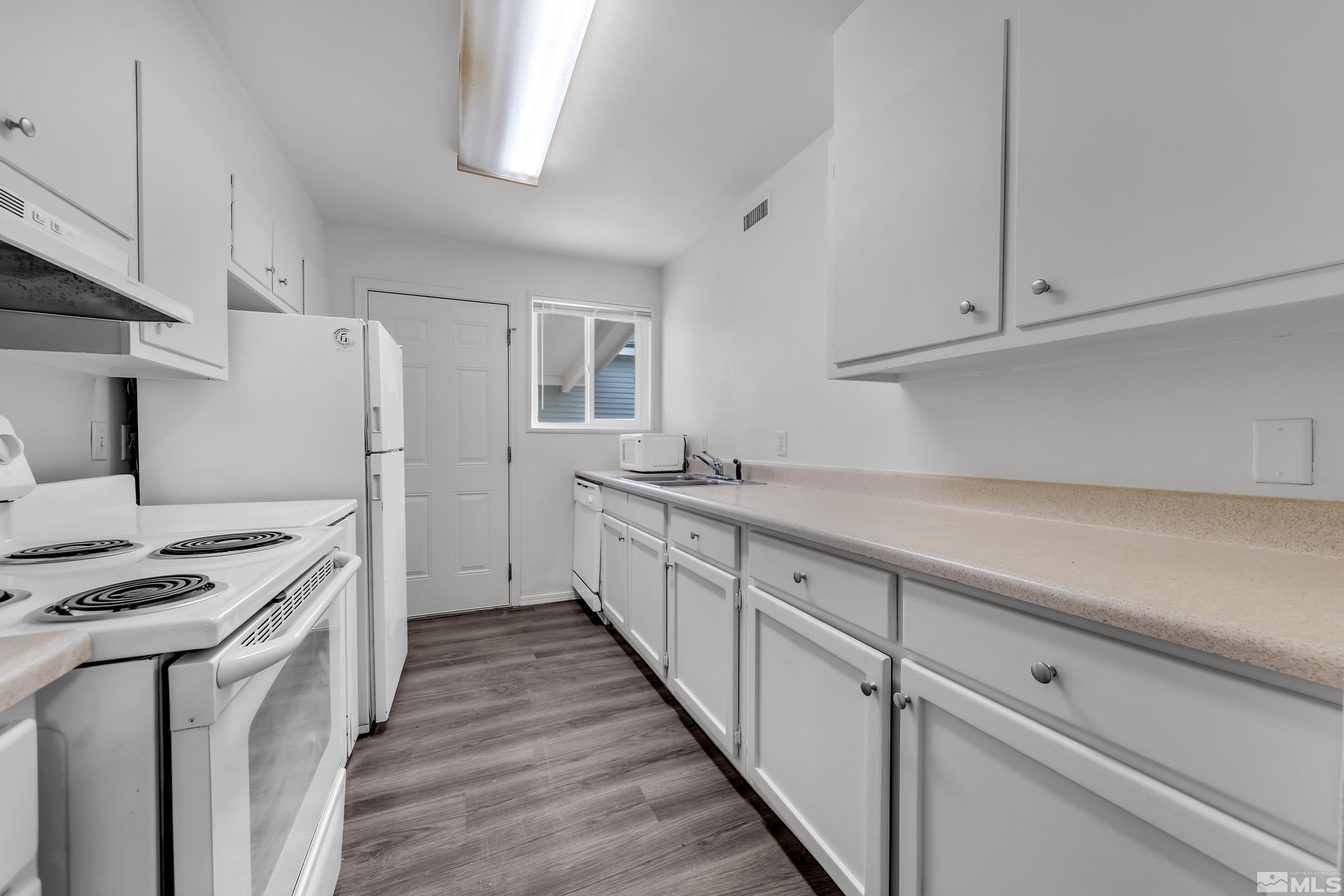 12000 Rocky Mountain Street Reno, NV 89506 - Photo 2 of 40 a kitchen with granite countertop white cabinets and white appliances