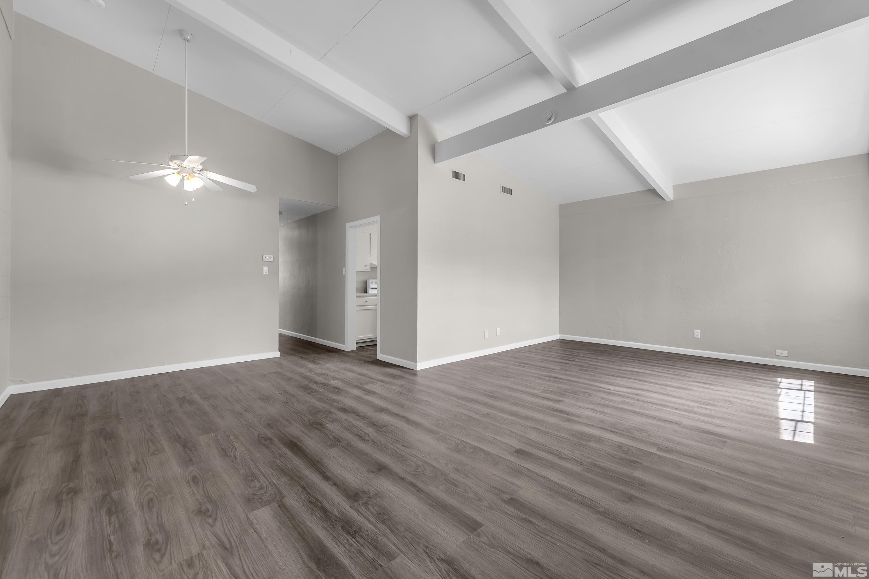 12000 Rocky Mountain Street Reno, NV 89506 - Photo 5 of 40 a view of an empty room with wooden floor and a window