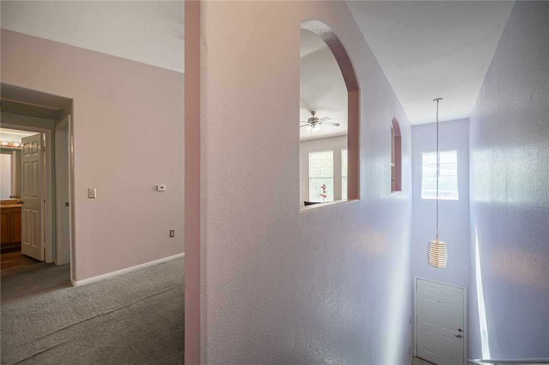 10550 West Alexander Road, Unit 2014 Las Vegas, NV 89129 - Photo 8 of 43 Arched wall cutouts overlook a bright two-story entryway from the upper-level hallway.