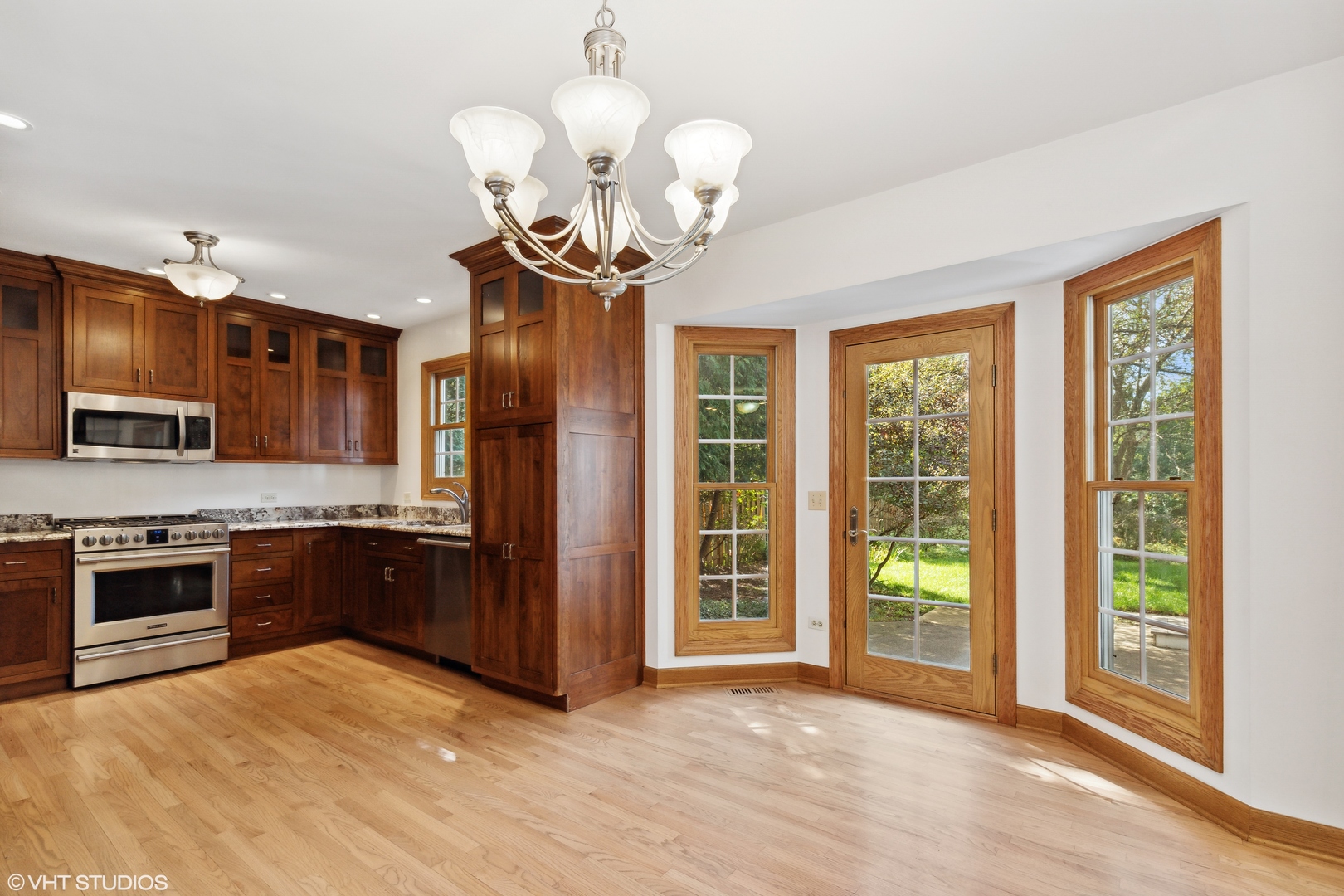 430 Long Hill Road Gurnee, IL 60031 - Photo 8 of 27 a view of a kitchen with a sink stainless steel appliances wooden floor and a large window