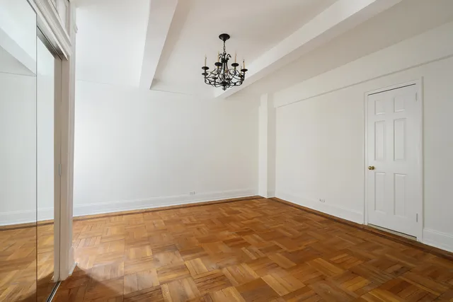 a bathroom with a granite countertop toilet sink and mirror
