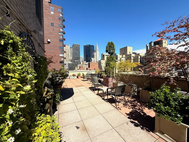 a view of swimming pool with outdoor seating and plants