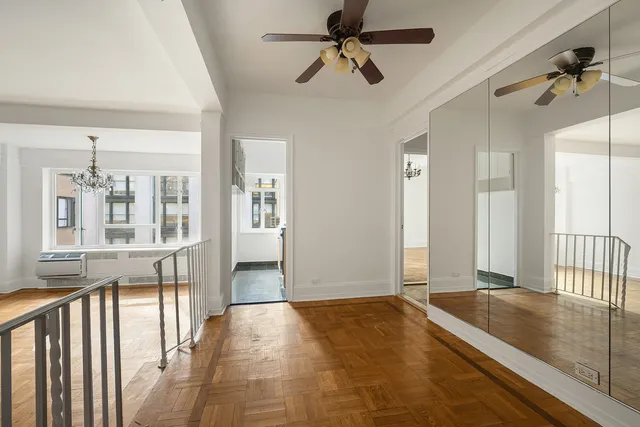 a kitchen with stainless steel appliances granite countertop a stove a sink and a refrigerator with white cabinets
