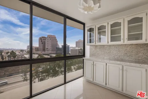 a spacious bedroom with a bed and a large window