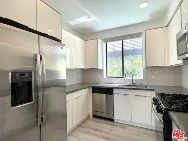 a kitchen with a sink stove and refrigerator