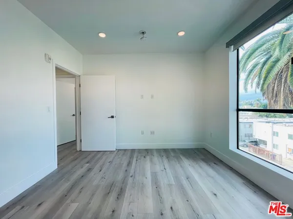 a view of room with window and wooden floor