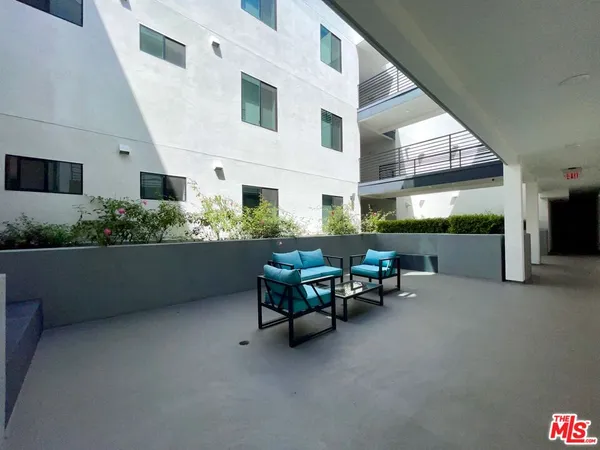 a backyard of a house with outdoor seating