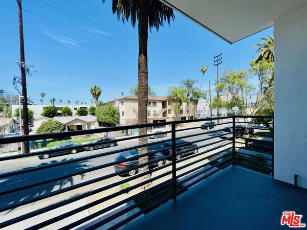 a view of a balcony with potted plants