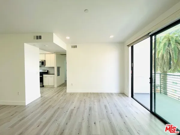 a view of a kitchen with wooden floor and a kitchen