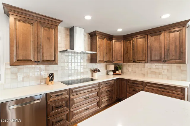 a kitchen with stainless steel appliances granite countertop a refrigerator a stove and a sink with wooden floor