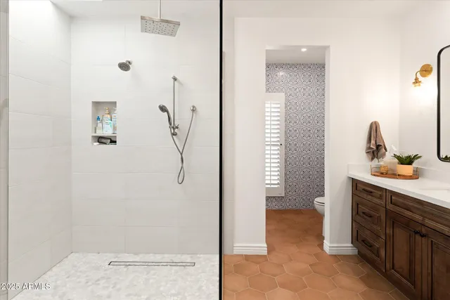 a bathroom with a sink vanity granite and a shower