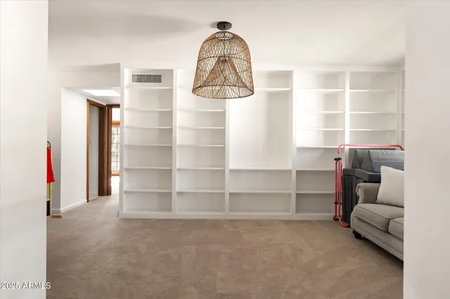 a view of a porch with wooden floor and a floor to ceiling window