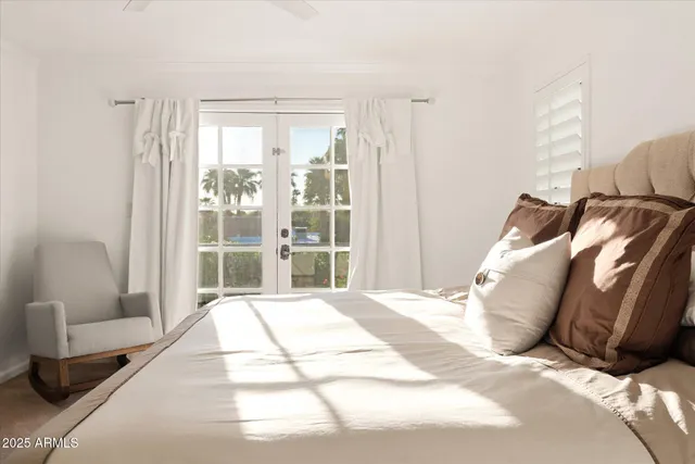 a view of a white house with a yard and large trees