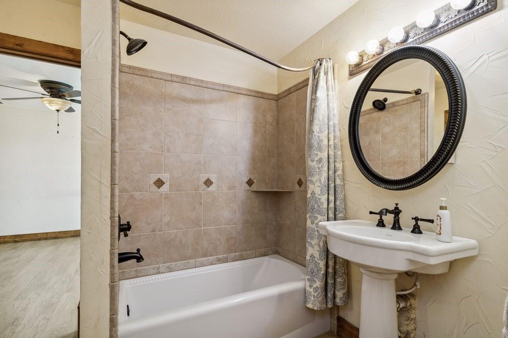 800 County Road 2807 Mabank, TX 75147 - Photo 27 of 40 a bathroom with a sink a mirror and a bathtub