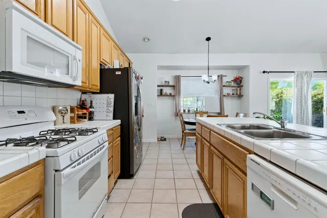 a kitchen with a stove and a refrigerator