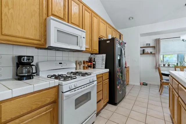 a kitchen with a table and chairs in it