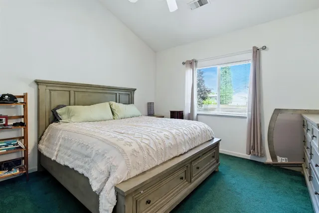 a bedroom with a bed and a dresser