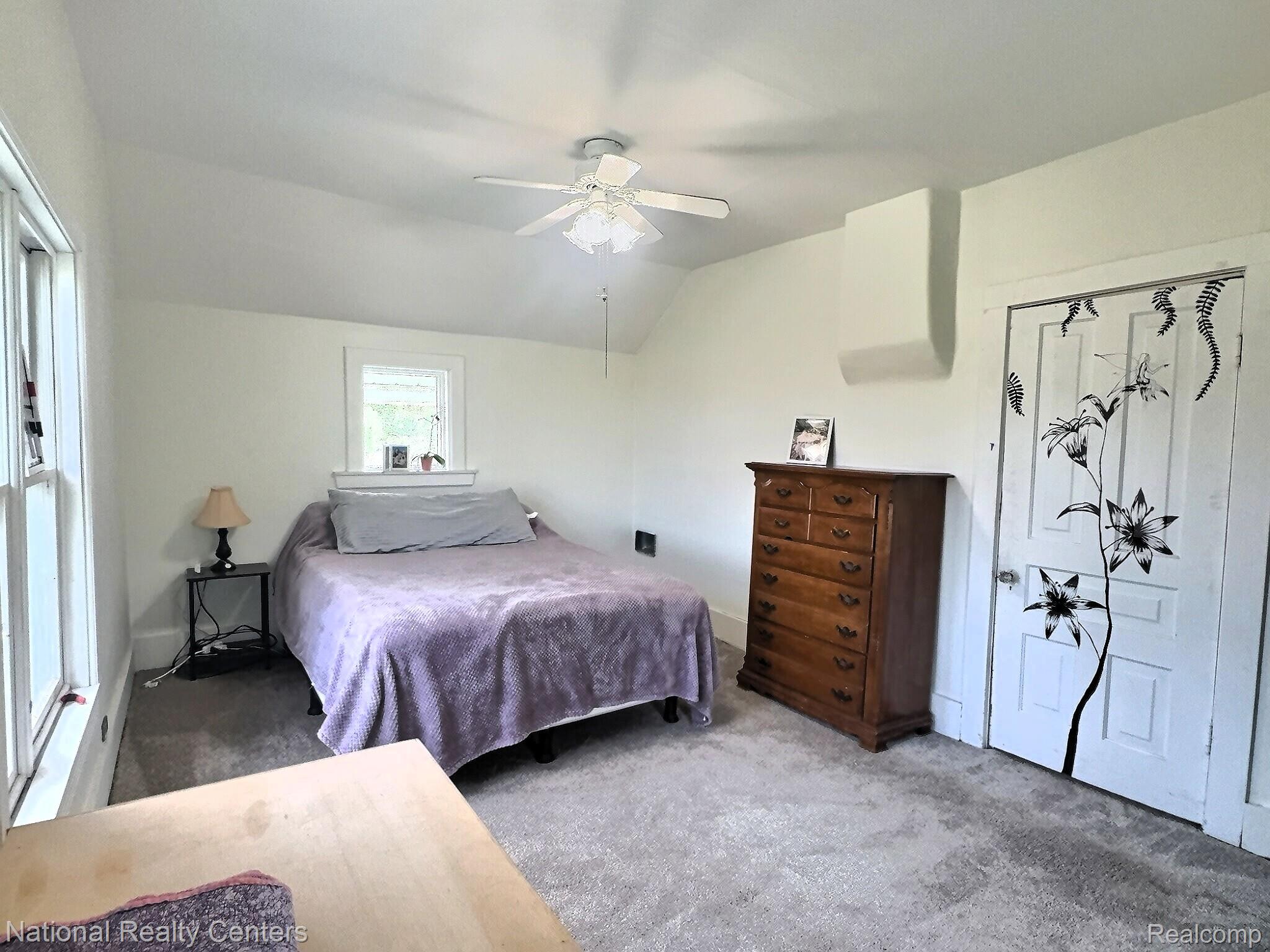 10667 West Sober Road Webberville, MI 48892 - Photo 24 of 28 Interior room featuring soft gray carpeting, white walls, and a ceiling fan