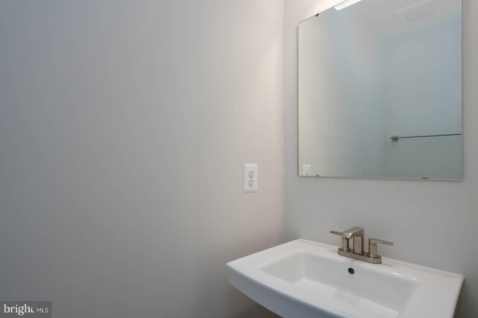 336 Paca Gardens Lane Frederick, MD 21703 - Photo 14 of 36 a bathroom with a sink and mirror