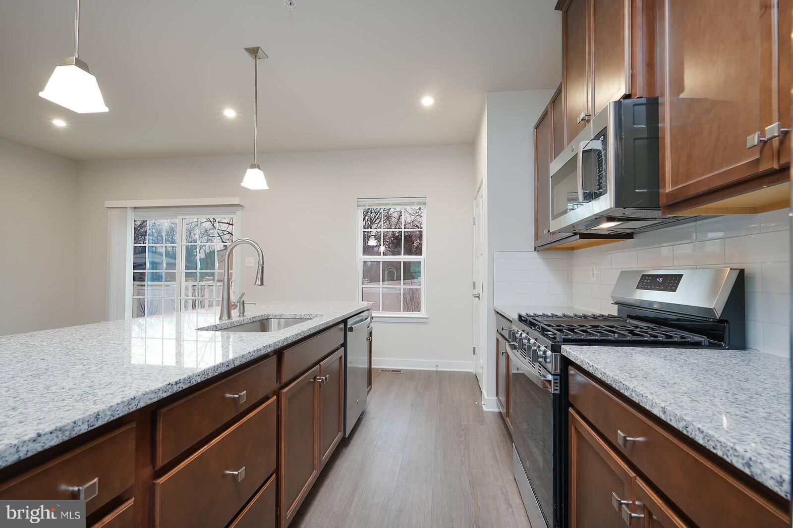 336 Paca Gardens Lane Frederick, MD 21703 - Photo 18 of 36 a kitchen with stainless steel appliances granite countertop a sink stove and cabinets