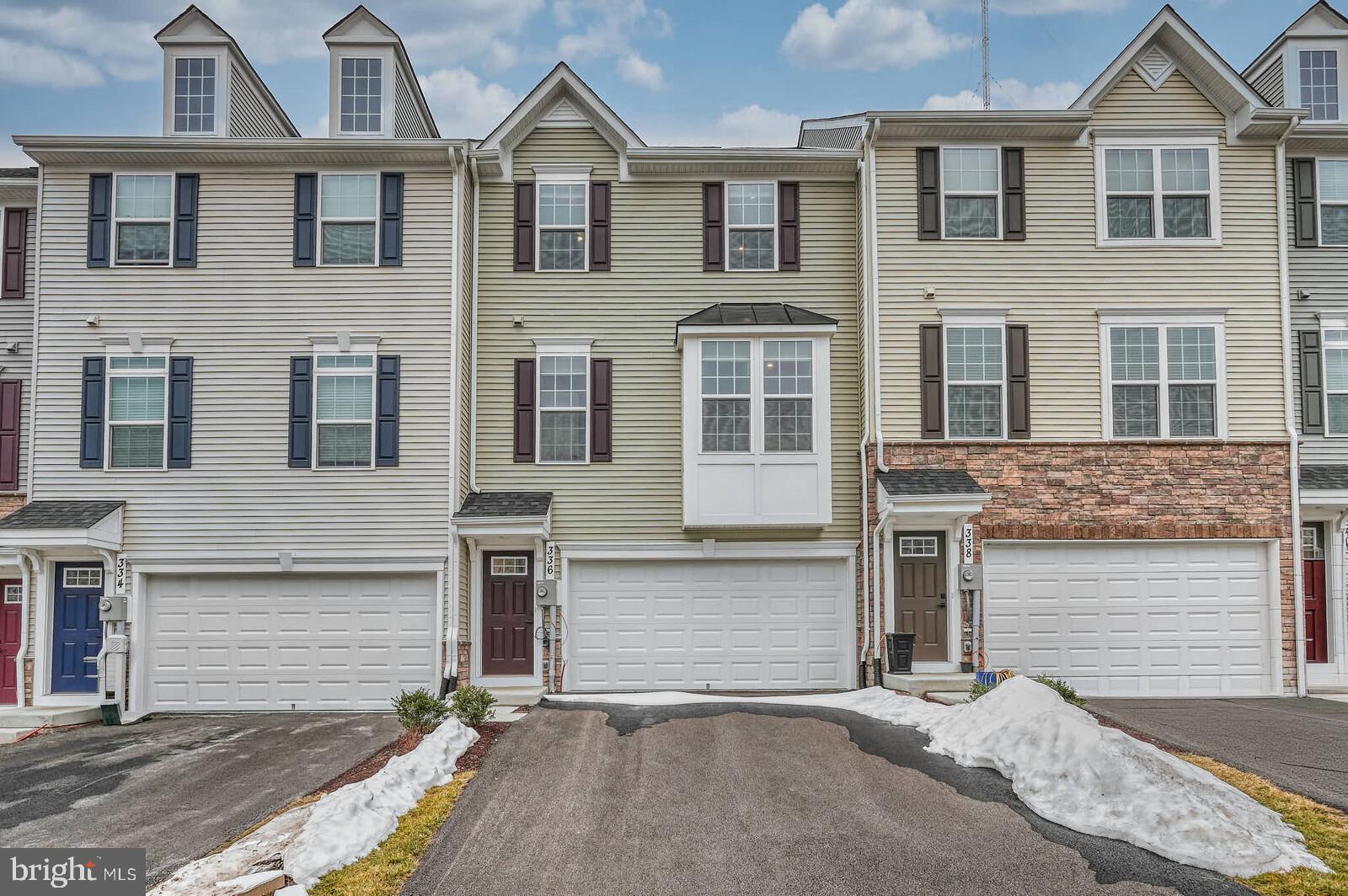 336 Paca Gardens Lane Frederick, MD 21703 - Photo 2 of 36 a view of a brick house with many windows