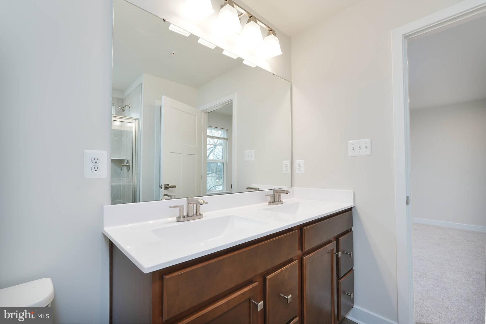 336 Paca Gardens Lane Frederick, MD 21703 - Photo 24 of 36 a bathroom with a sink and a mirror
