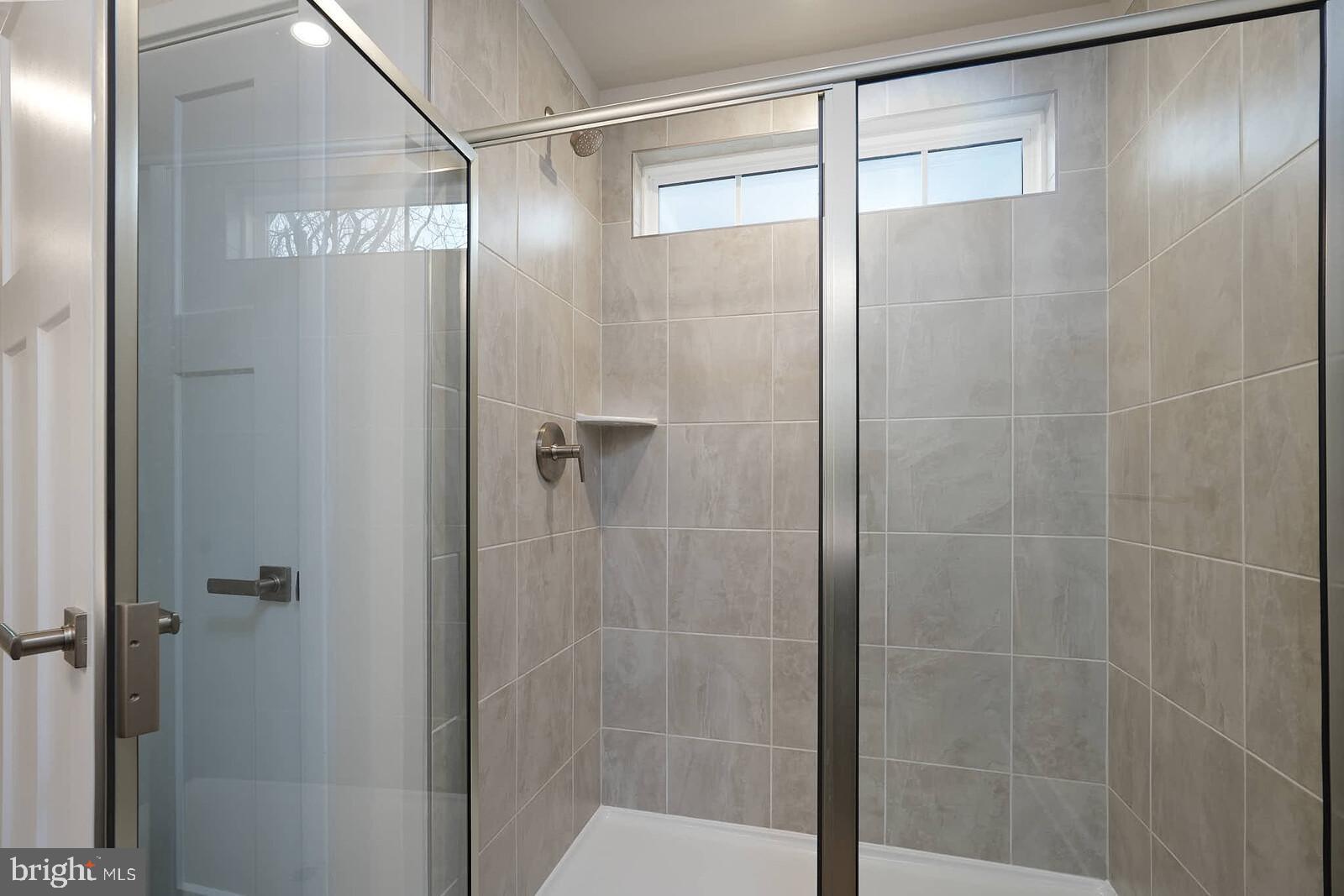 336 Paca Gardens Lane Frederick, MD 21703 - Photo 25 of 36 a bathroom that has a glass shower door