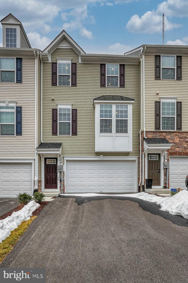 336 Paca Gardens Lane Frederick, MD 21703 - Photo 3 of 36 a front view of a house with a yard